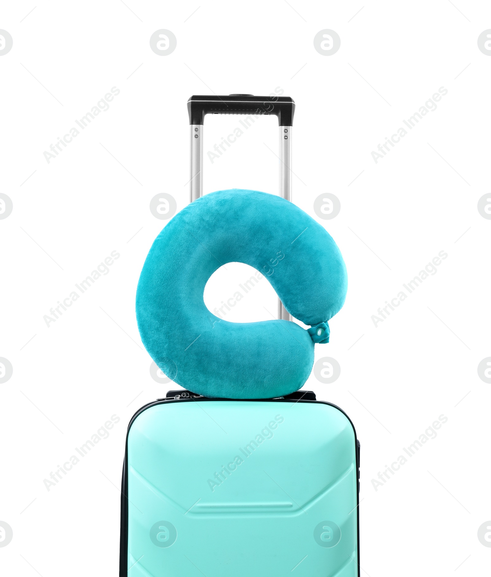 Photo of Soft travel pillow on turquoise suitcase isolated on white