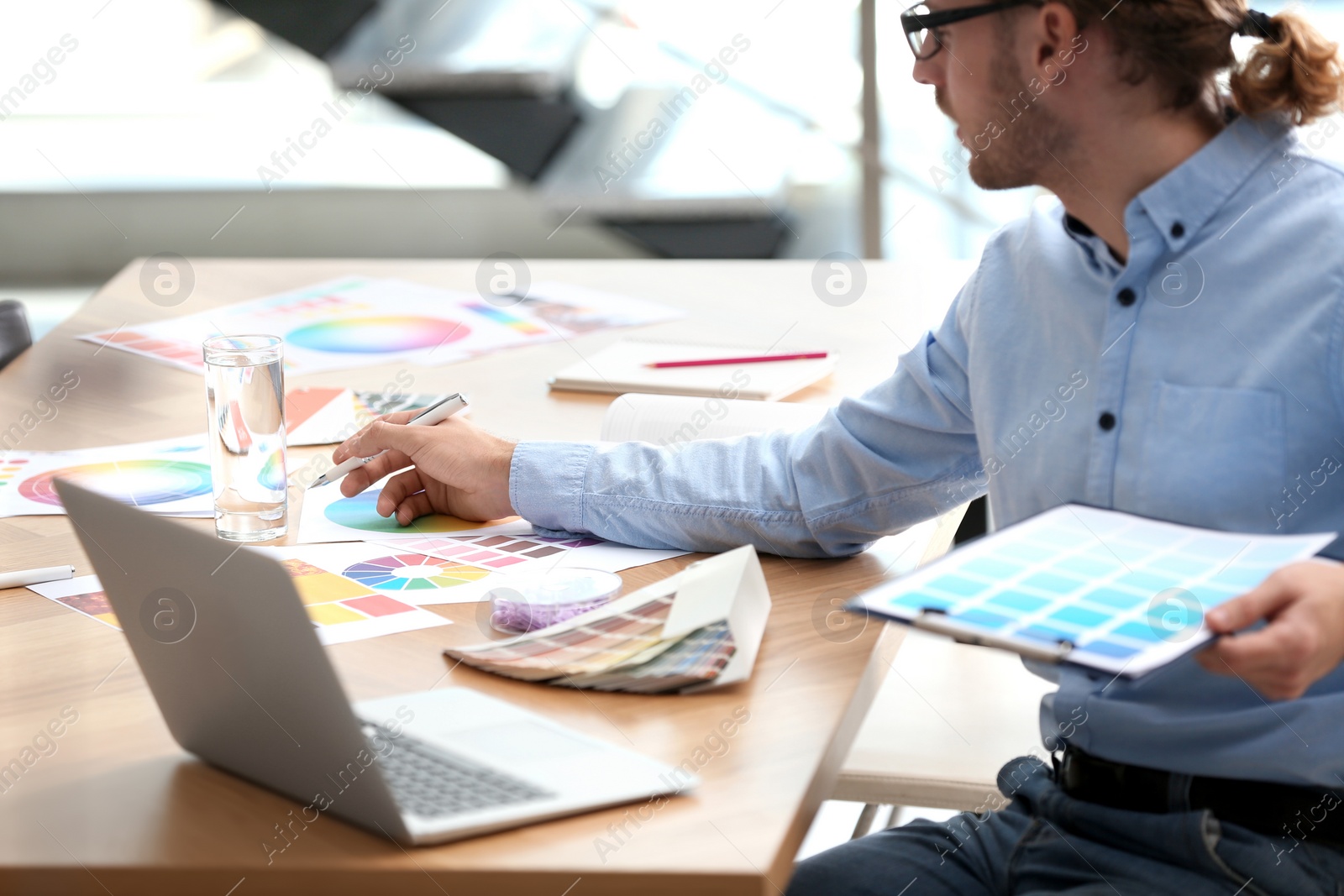 Photo of Professional interior designer at workplace in office, closeup