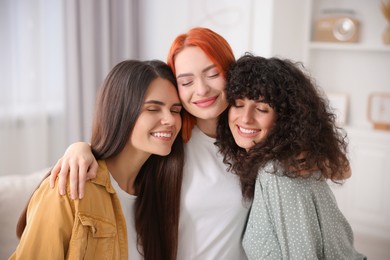 Photo of Portrait of happy young friends at home
