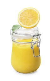 Delicious lemon curd in glass jar, fresh citrus fruit and green leaf isolated on white
