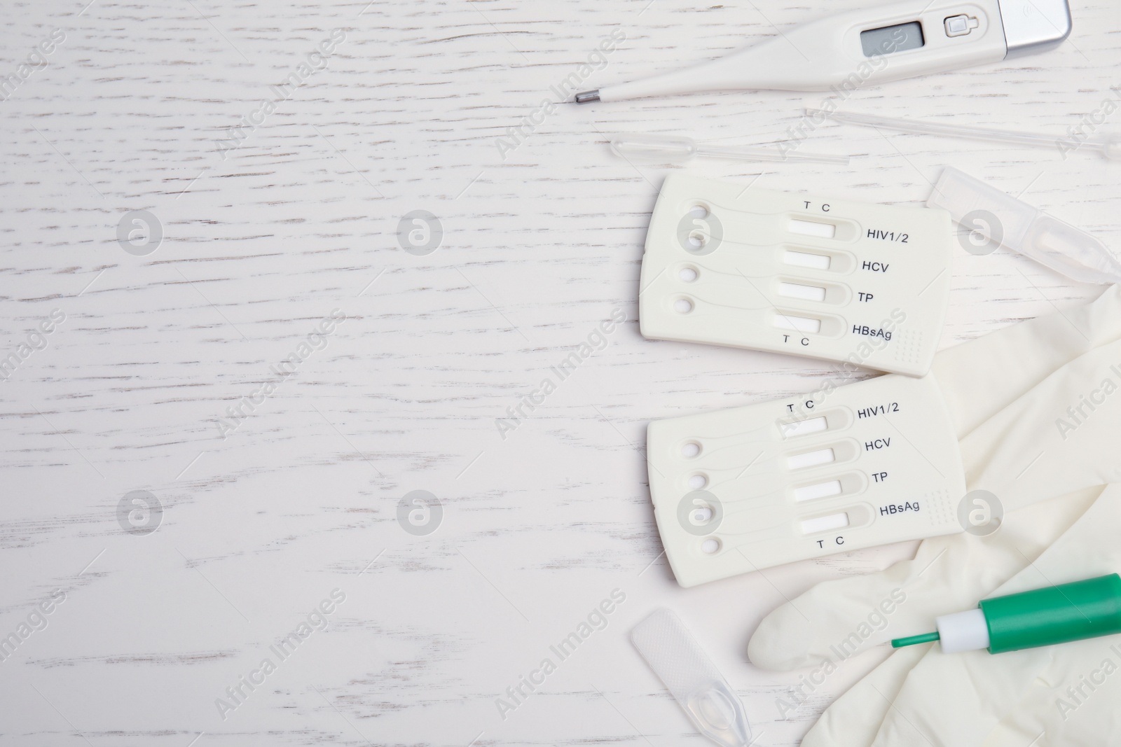 Photo of Disposable express hepatitis test kit on white wooden table, flat lay. Space for text