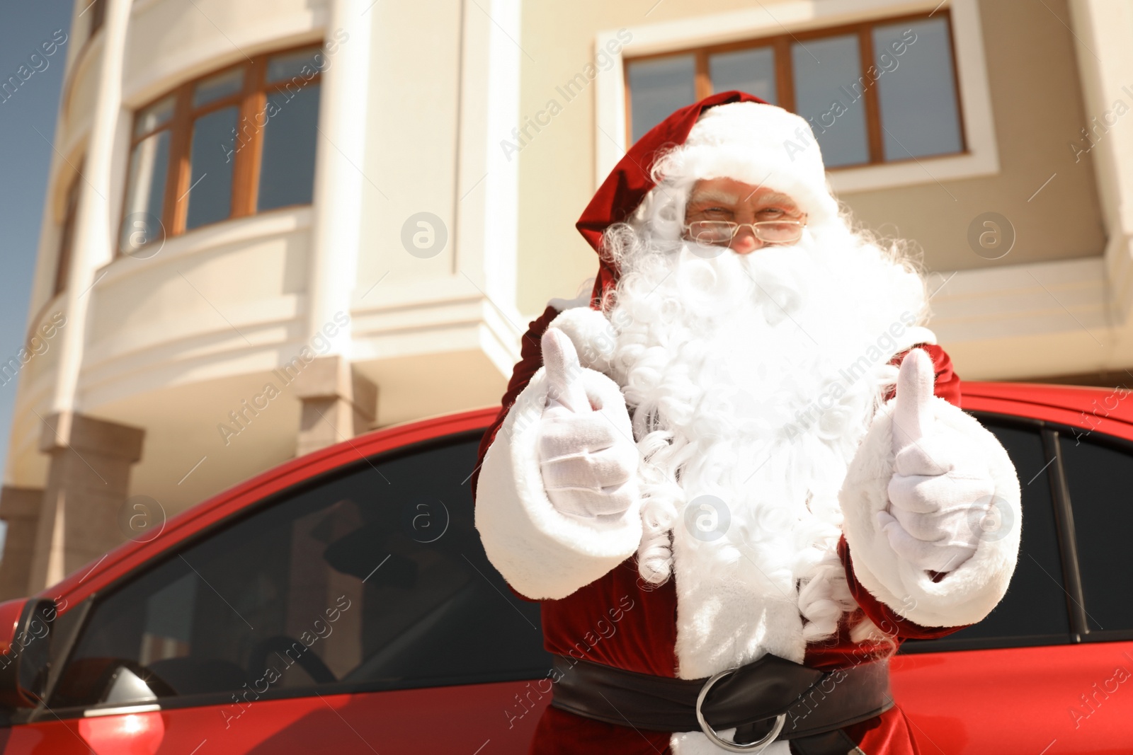 Photo of Authentic Santa Claus near modern car outdoors