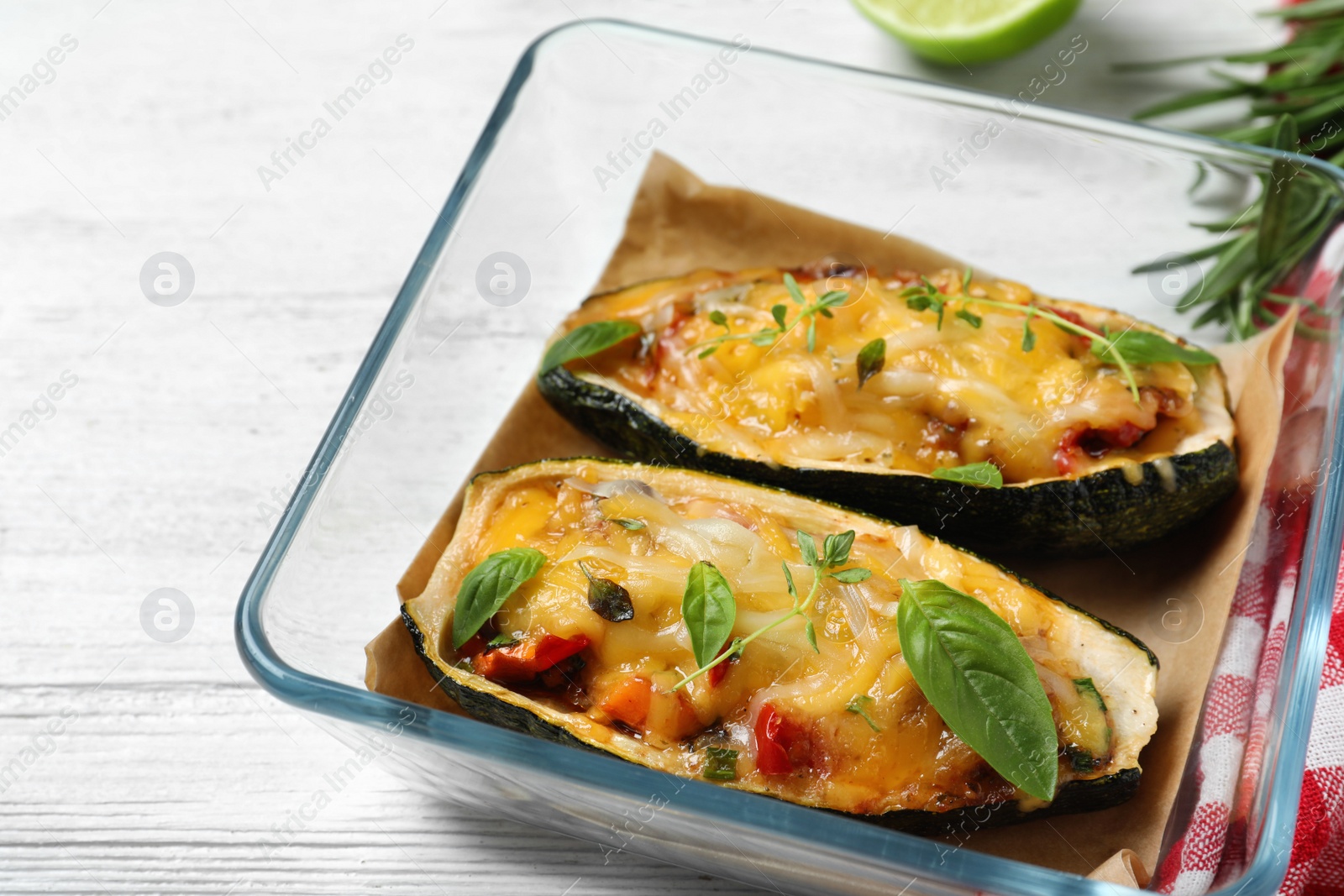 Photo of Tasty baked stuffed zucchini on white wooden table