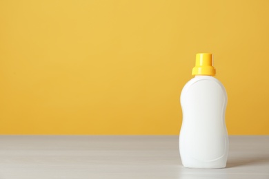 Photo of Bottle of cleaning product on light table. Space for text