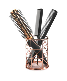 Photo of New modern hair brush and combs in metal holder isolated on white