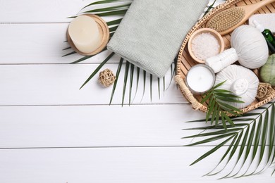 Photo of Flat lay composition with candle and different spa products on white wooden table. Space for text