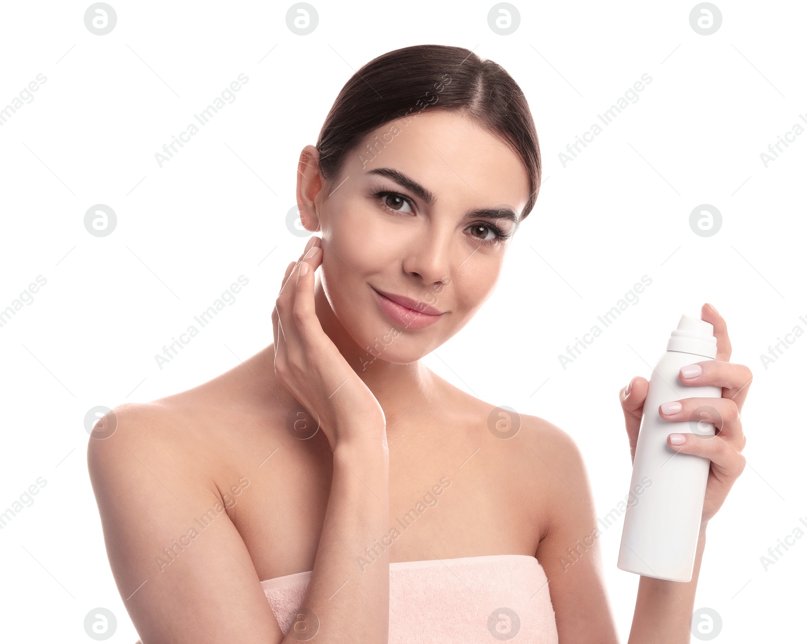 Photo of Young woman with bottle of thermal water on white background. Cosmetic product