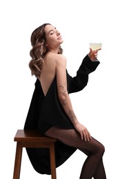 Photo of Beautiful woman in stylish black outfit with glass of drink posing on white background