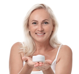 Portrait of beautiful mature woman with perfect skin holding jar of cream on white background