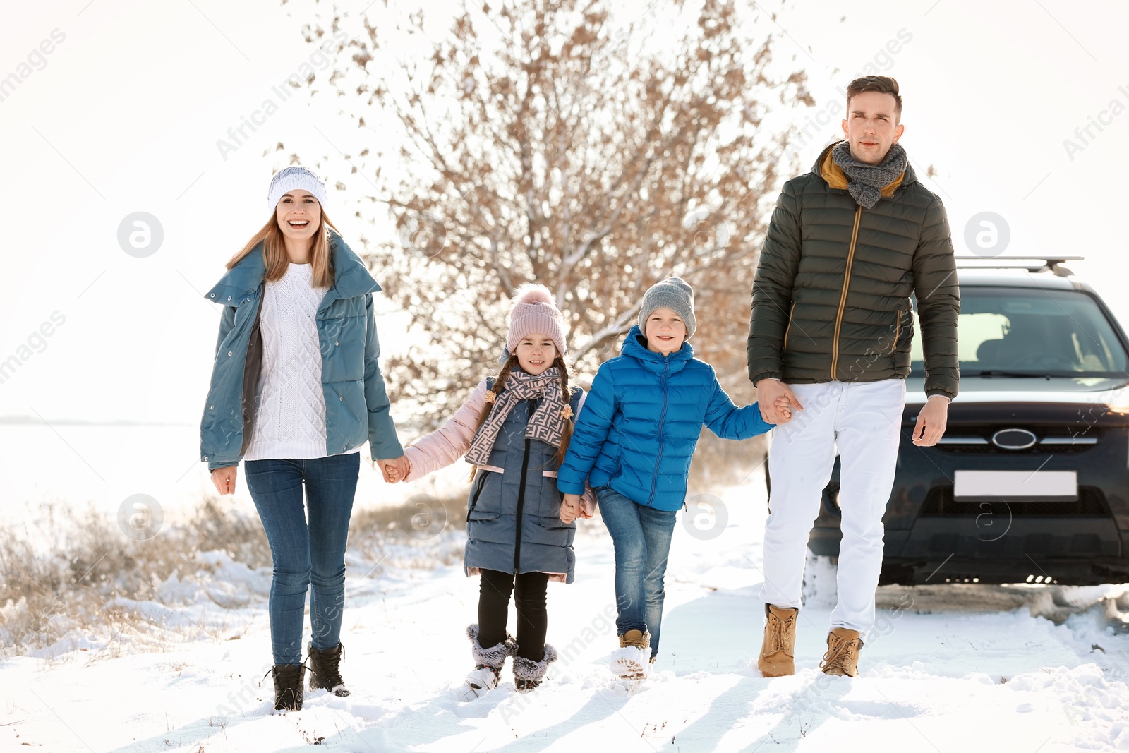 Photo of Happy family walking in countryside on winter day