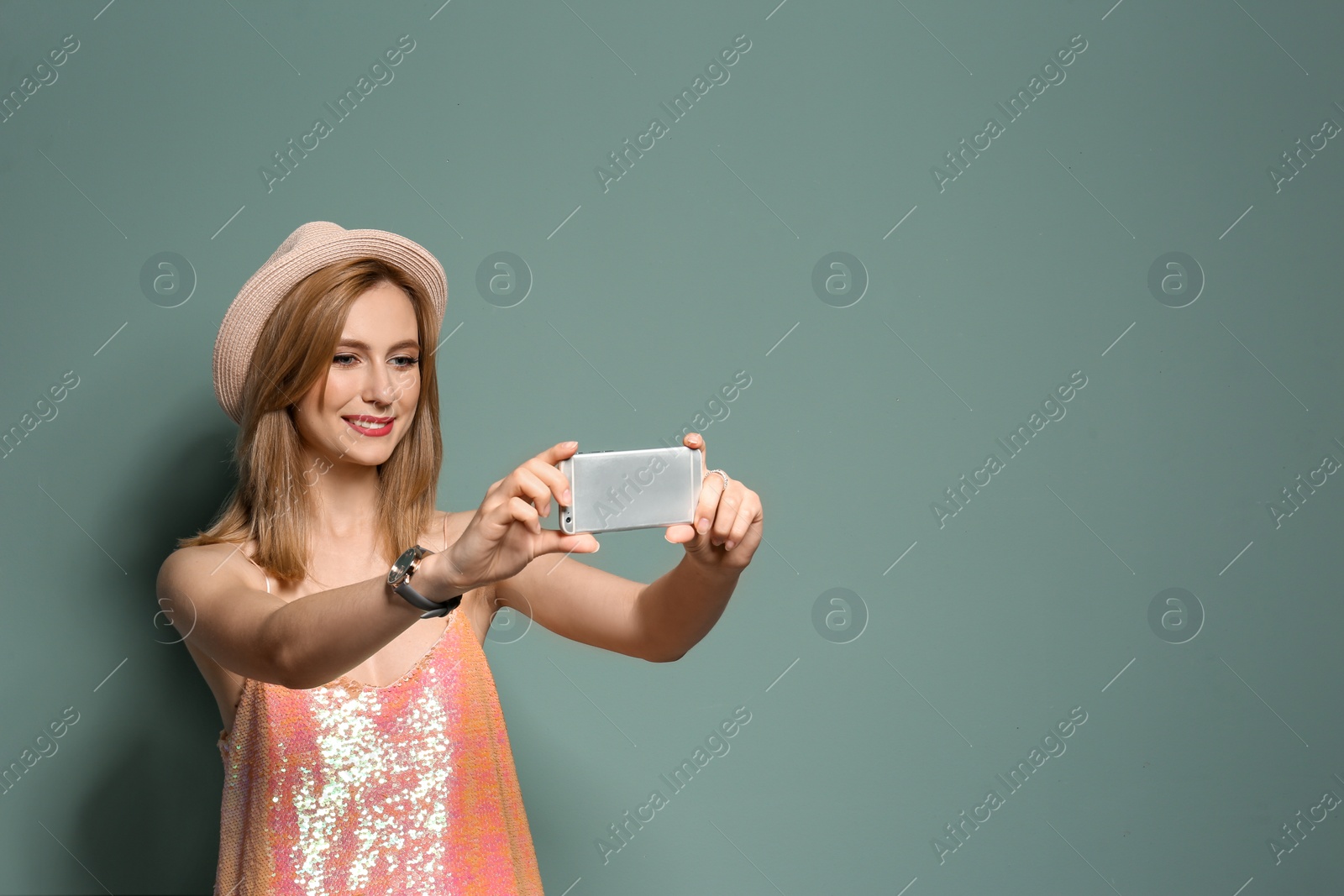 Photo of Attractive young woman taking selfie on color background