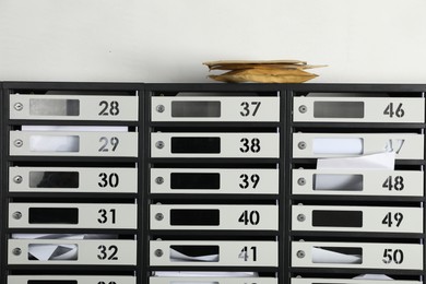 Photo of New mailboxes with keyholes, numbers, receipts and envelopes in post office