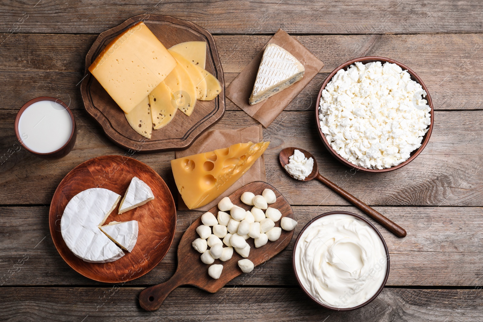 Photo of Flat lay composition with dairy products on wooden table