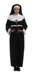 Young nun reading Bible on white background