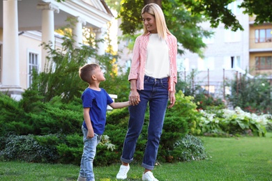 Nanny with cute little boy together on sunny day