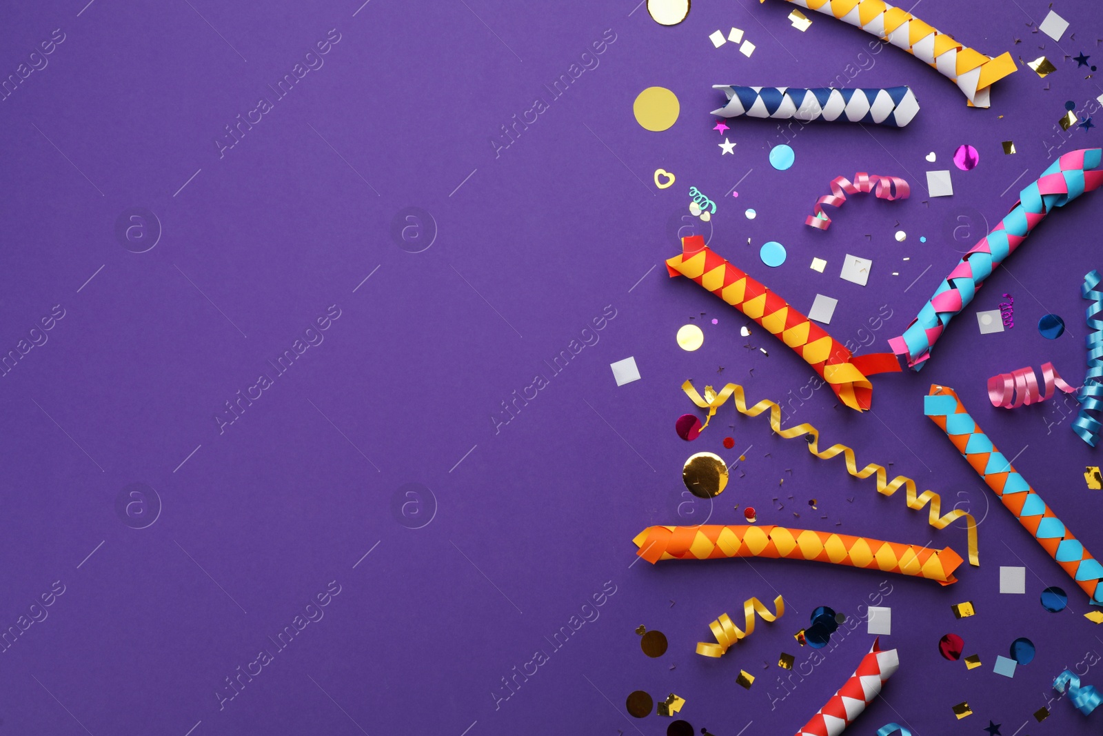 Photo of Flat lay composition with carnival items on purple background. Space for text