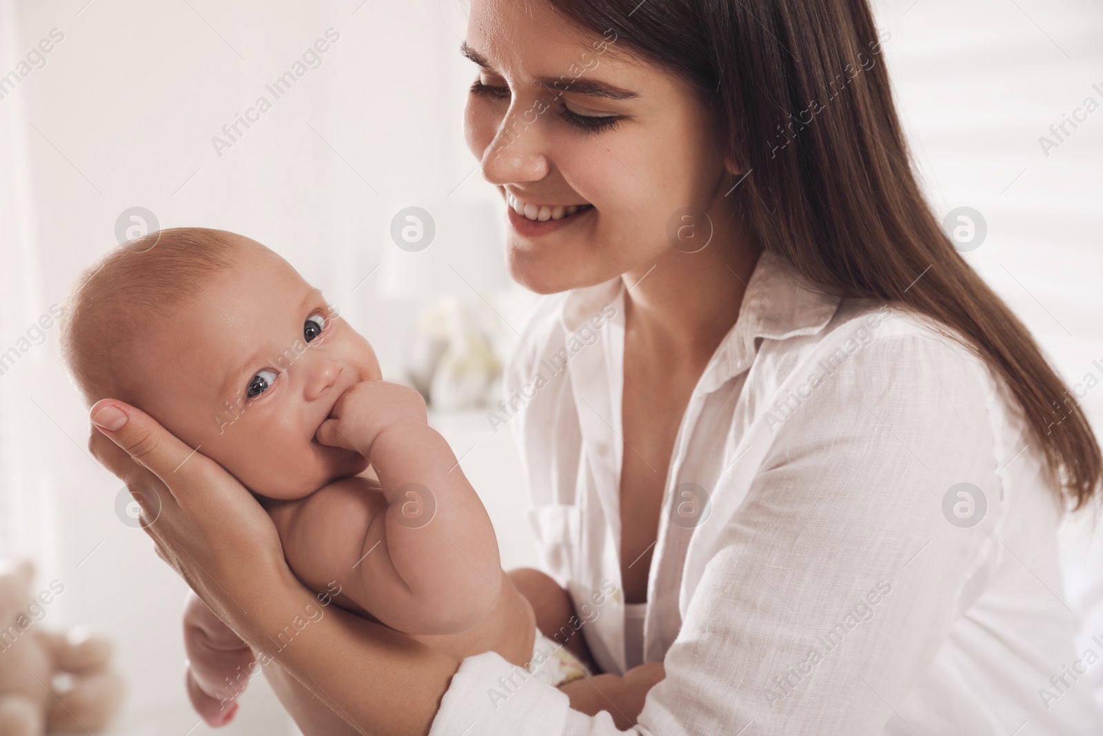 Photo of Happy young mother with her cute baby at home