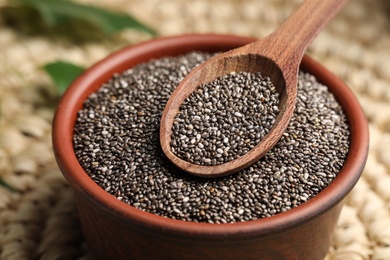 Photo of Bowl and spoon with chia seeds, closeup