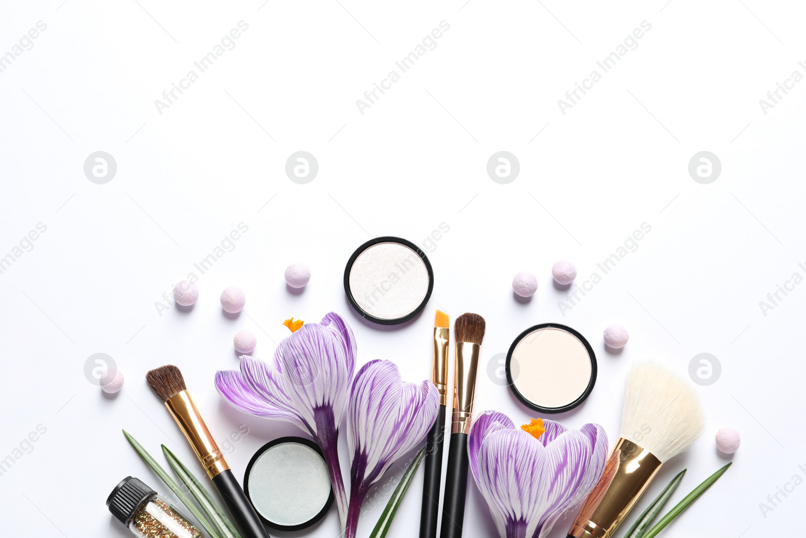 Photo of Different makeup products and flowers on white background, top view