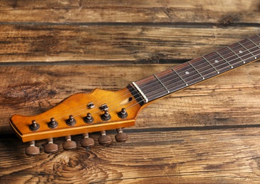 Modern electric guitar on wooden background. Musical instrument