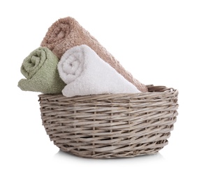 Photo of Wicker basket with clean towels isolated on white