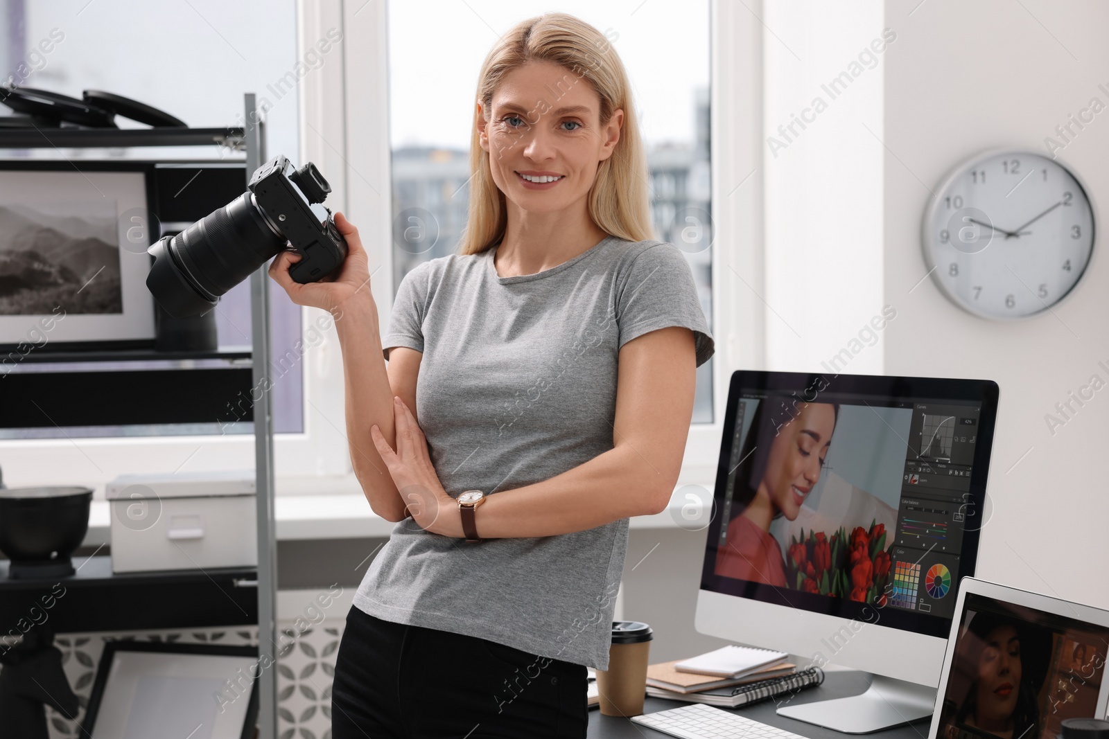 Photo of Professional photographer with modern digital camera in office