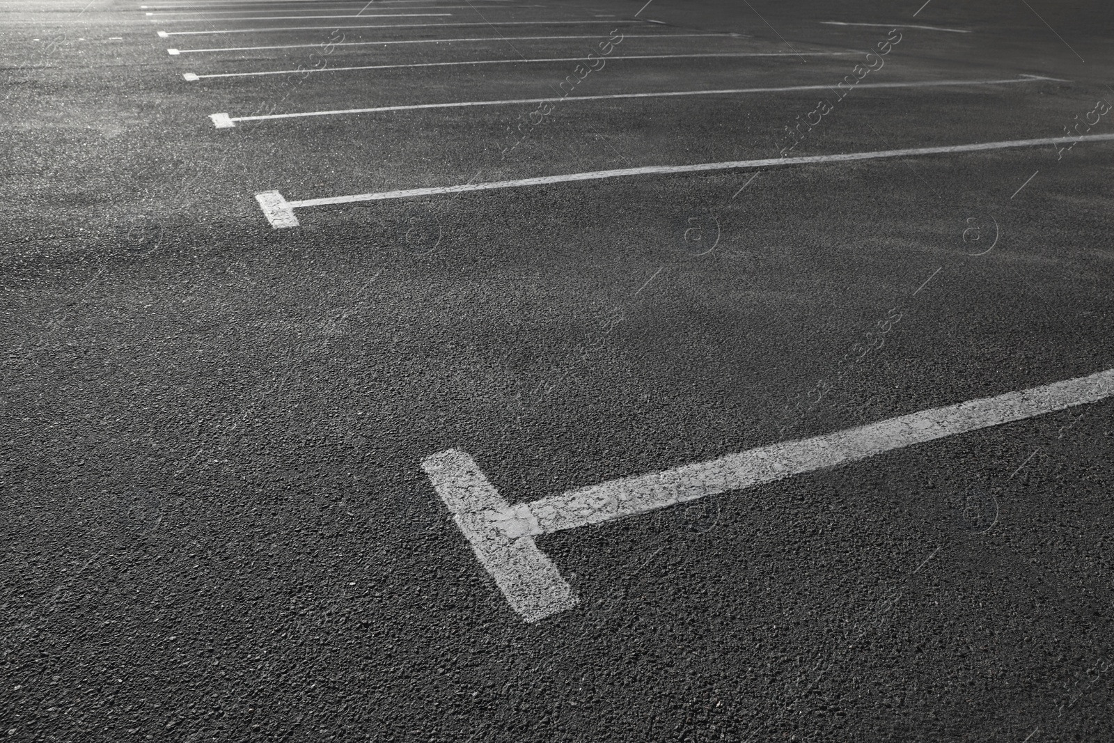 Photo of Car parking lot with white marking outdoors