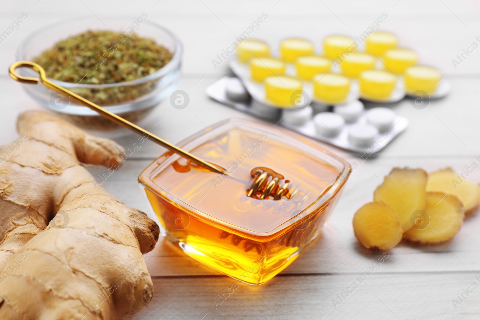 Photo of Cold remedies and pills on white wooden table, closeup. Cough treatment