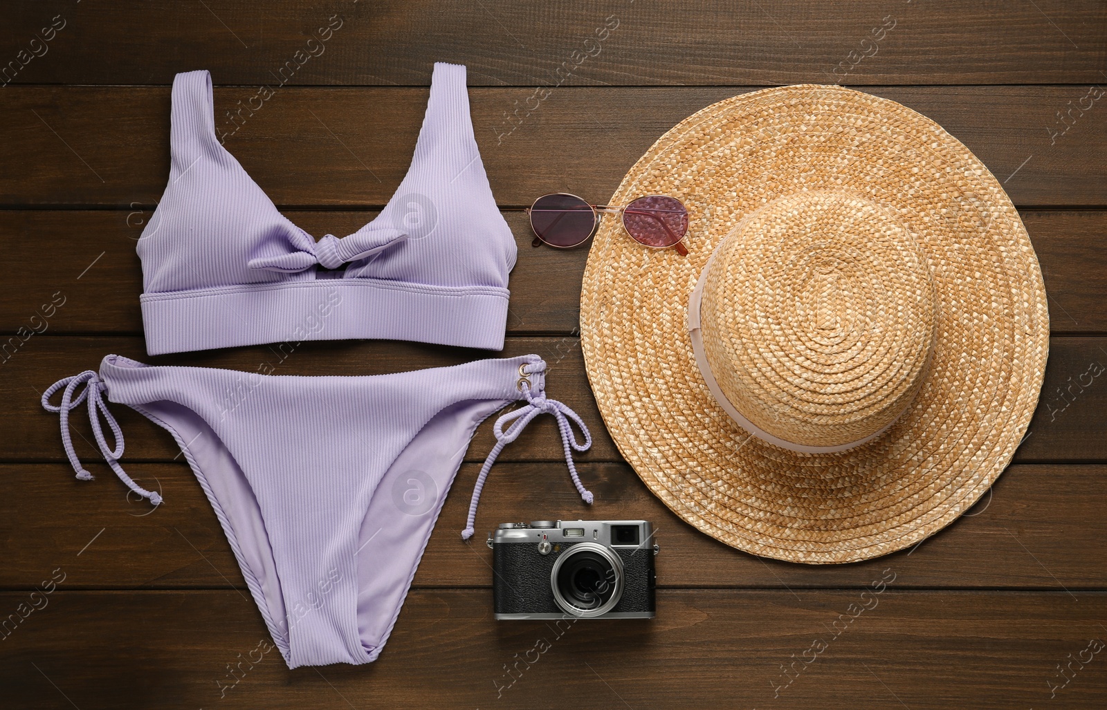 Photo of Different beach objects on wooden background, flat lay