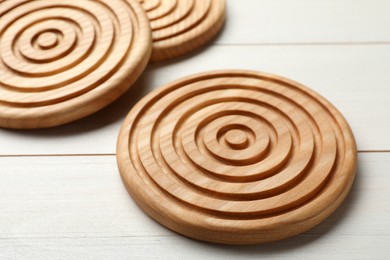 Stylish wooden cup coasters on white table