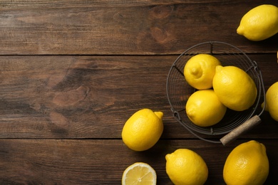 Photo of Flat lay composition with lemons on wooden background