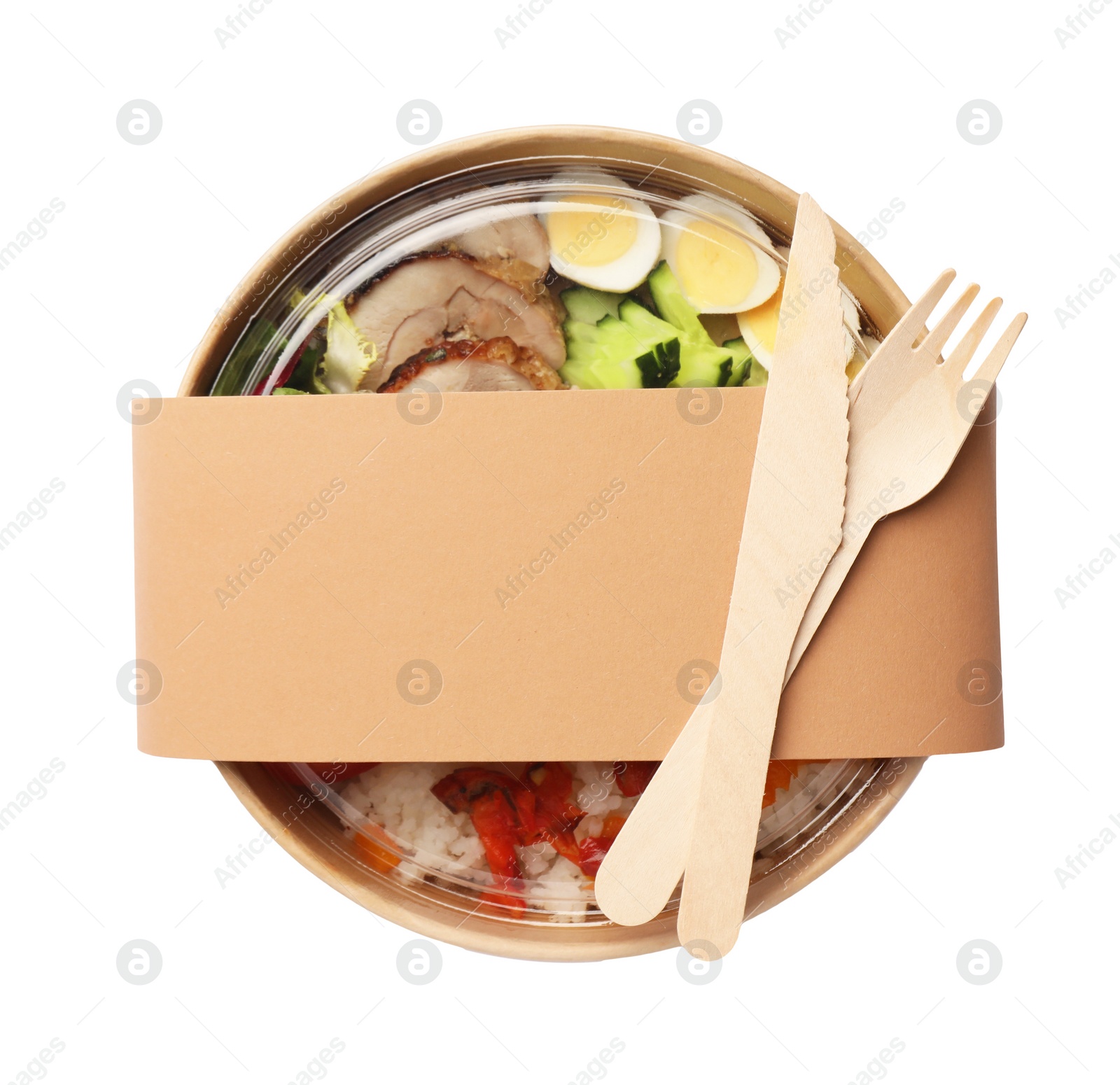 Photo of Tasty food in container with wooden fork and knife isolated on white, top view