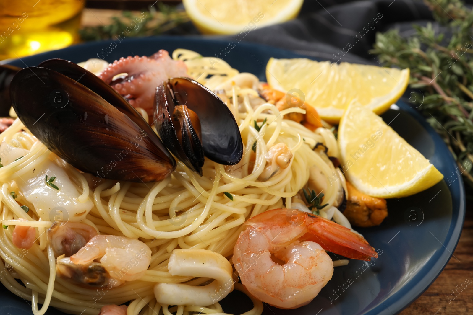 Photo of Delicious pasta with sea food on table, closeup