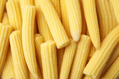 Photo of Tasty fresh yellow baby corns as background, top view