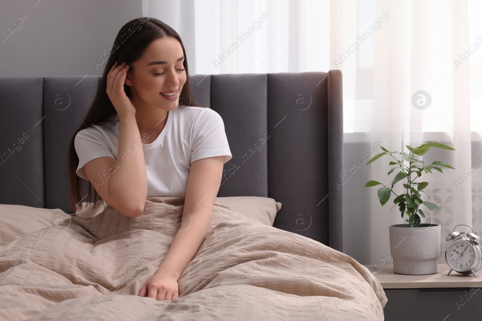 Photo of Beautiful woman in bed at home. Lazy morning