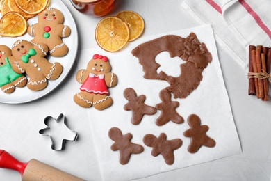 Photo of Flat lay composition with homemade gingerbread man cookies on light table