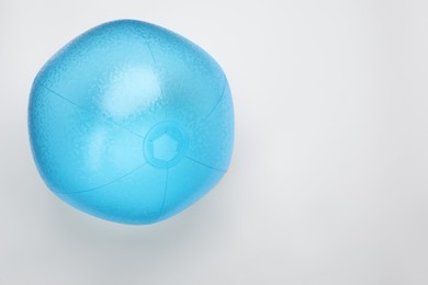 Photo of Light blue beach ball on white background, top view. Space for text