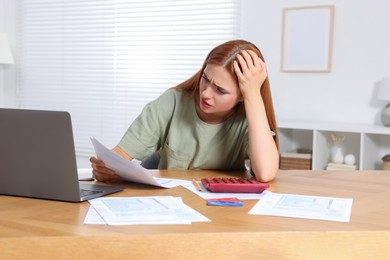 Woman doing taxes at table in room