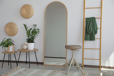 Photo of Stylish room interior with leaning floor mirror