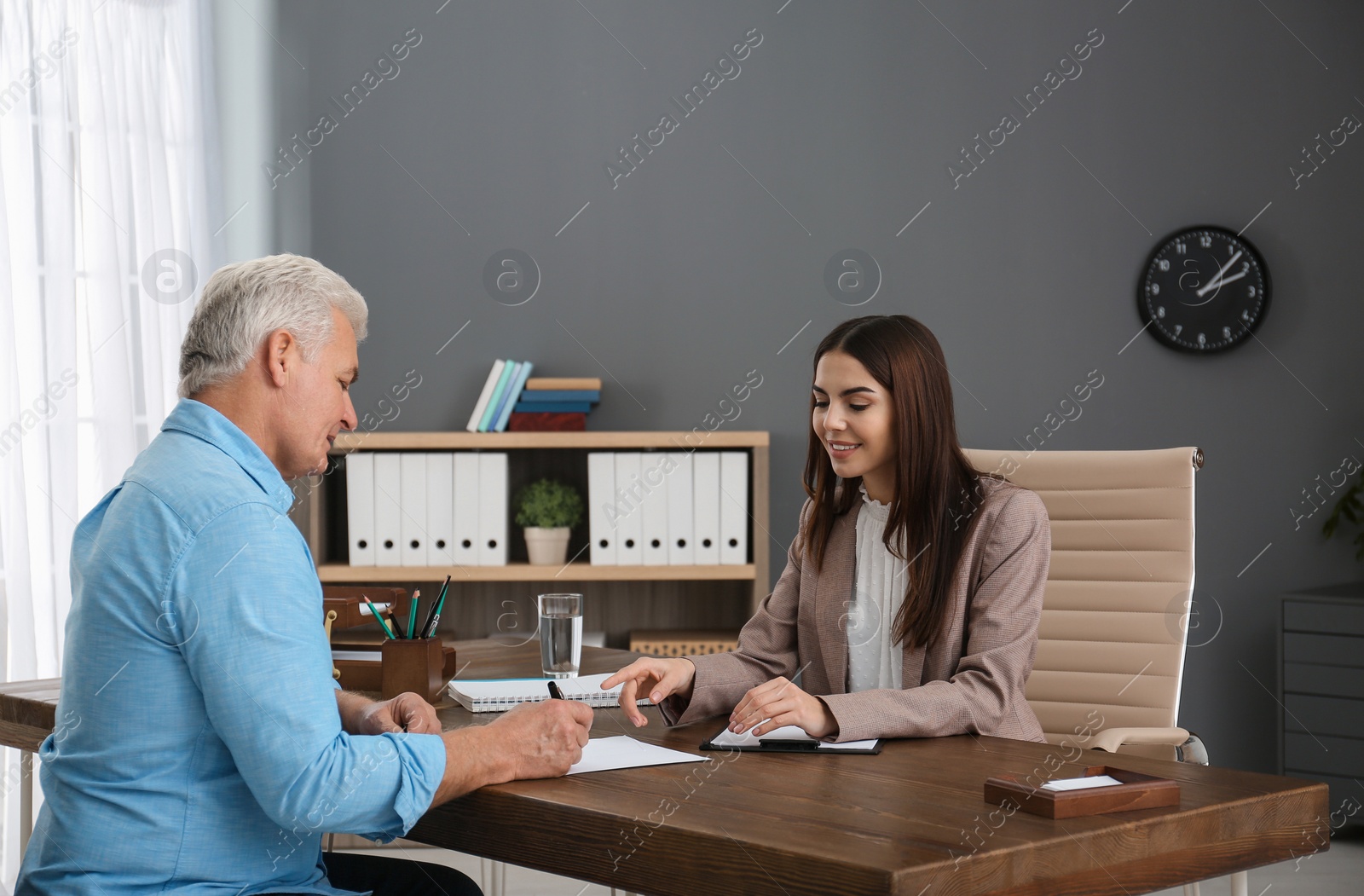Photo of Lawyer having meeting with senior client in office
