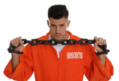 Prisoner in orange jumpsuit with chained hands on white background