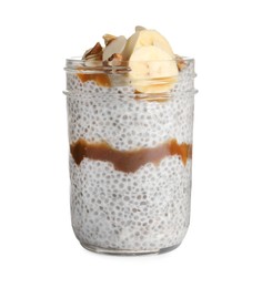 Delicious chia pudding with banana, walnuts and caramel sauce on white background