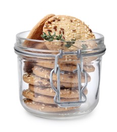 Photo of Cereal crackers with flax, sesame seeds and thyme in jar isolated on white