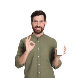 Photo of Happy man with phone showing okay gesture on white background