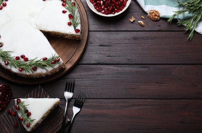 Photo of Traditional homemade Christmas cake served on wooden table, flat lay. Space for text