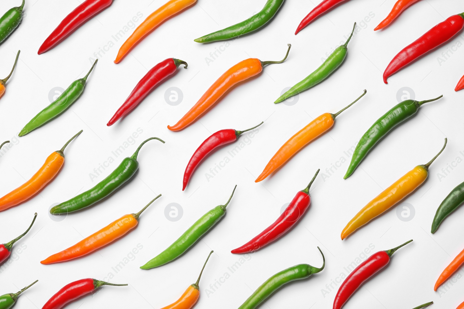 Photo of Different hot chili peppers on white background, top view