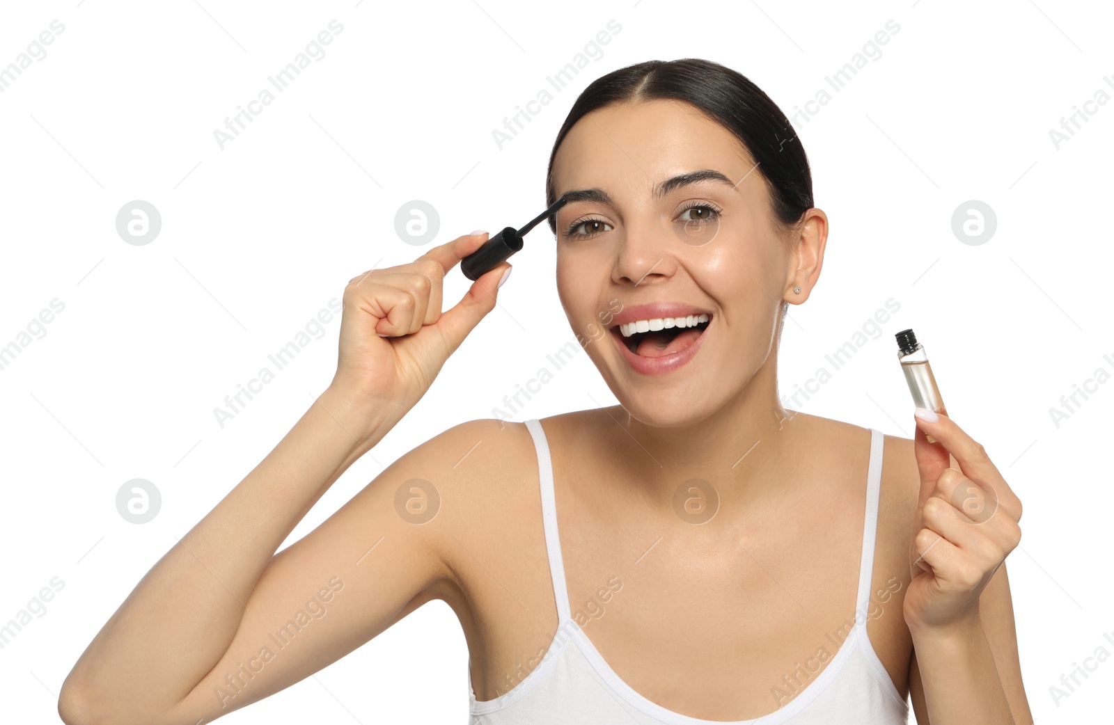 Photo of Young woman applying oil onto eyelashes on white background