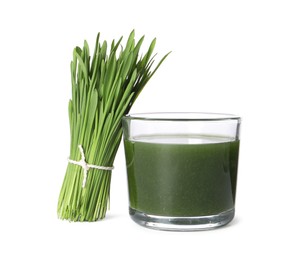 Photo of Wheat grass drink in glass and fresh green sprouts isolated on white