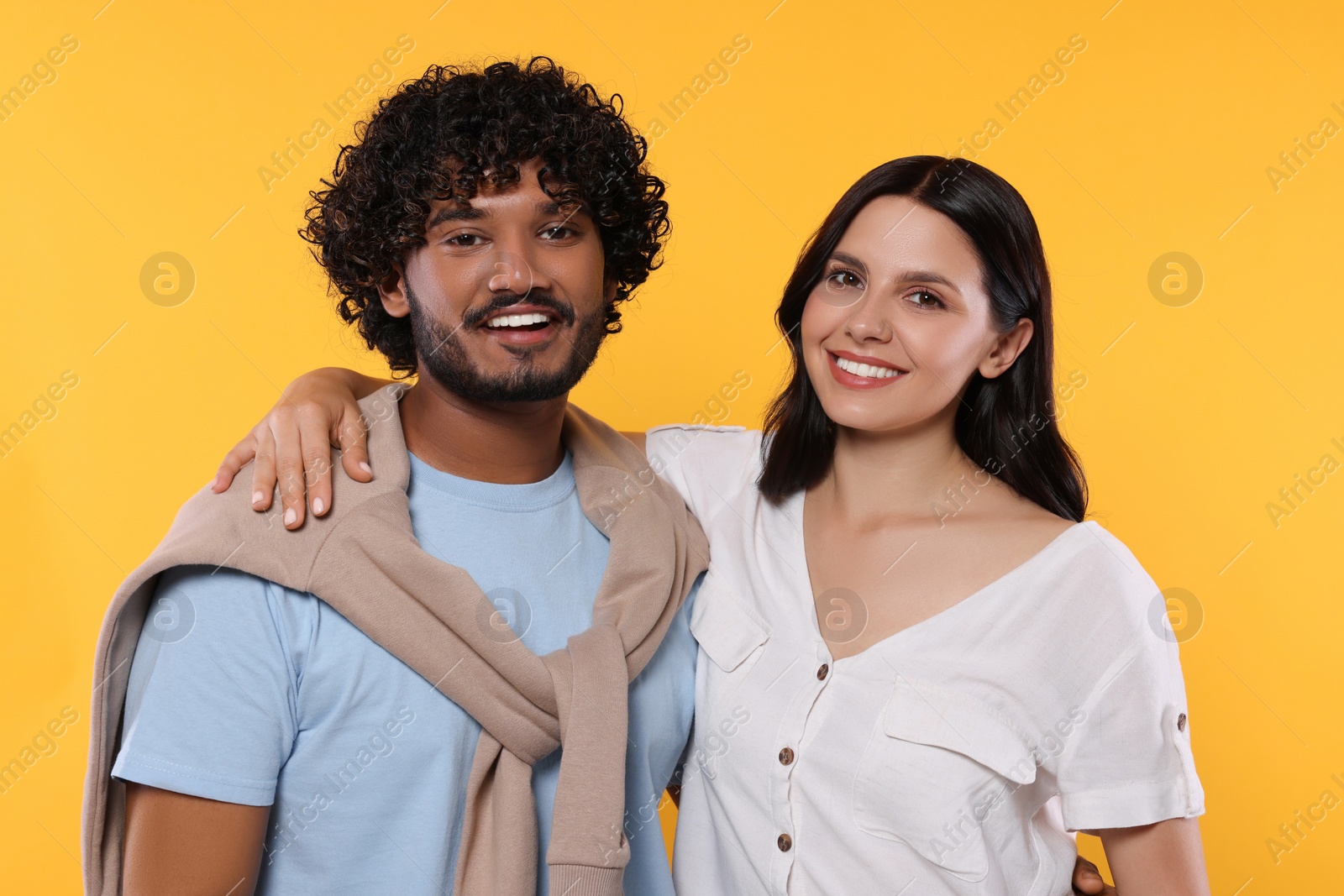 Photo of International dating. Portrait of happy couple on yellow background