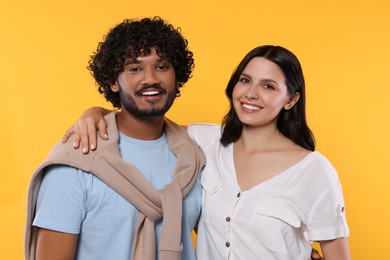 International dating. Portrait of happy couple on yellow background